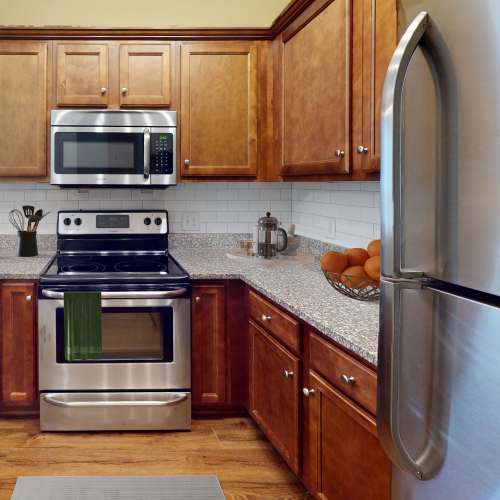 Kitchen with custom cherry cabinets at Sage Creek Apartments in Augusta, Georgia