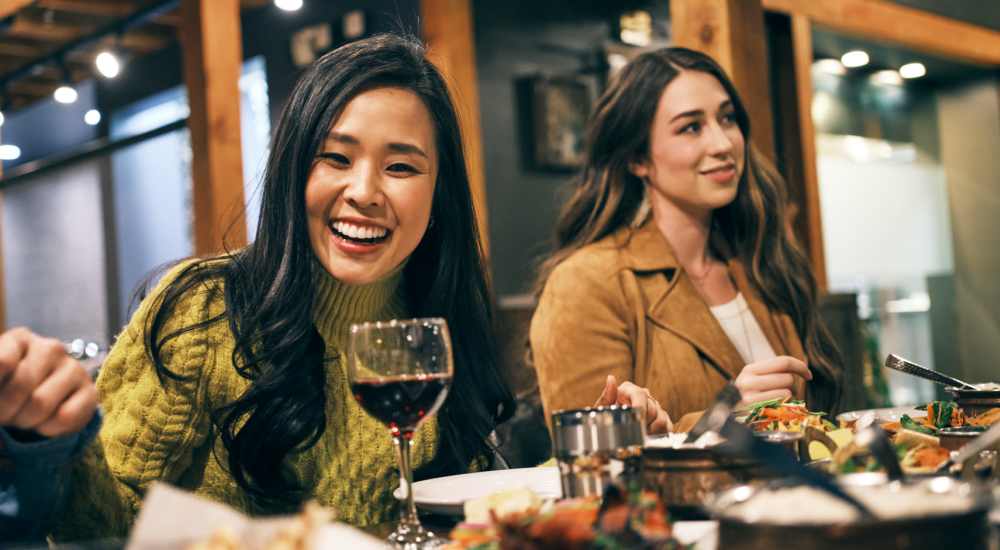Friends enjoying a meal near The Meadowlark at Fairview in Fairview, Oregon
