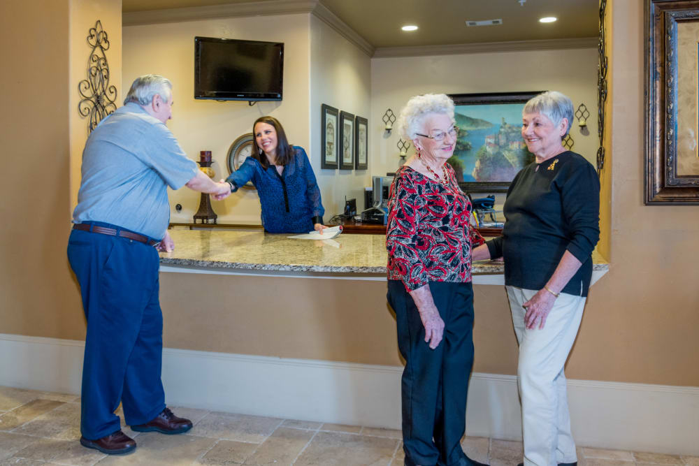 Friendly and helpful front desk employee at an Integrated Senior Lifestyles community