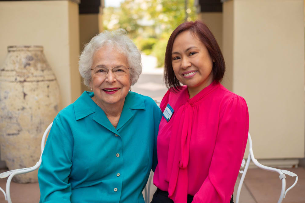 Resident and team member posing for a picture at Merrill Gardens at Campbell in Campbell, California. 