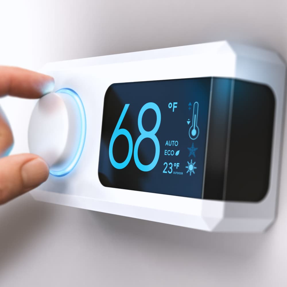 Resident adjusting thermostat at Woodlawn Lofts in Pittsburgh, Pennsylvania