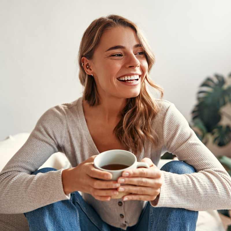 Resident relaxing in her apartment home at Branch Creek Apartments in Carrollton, Texas