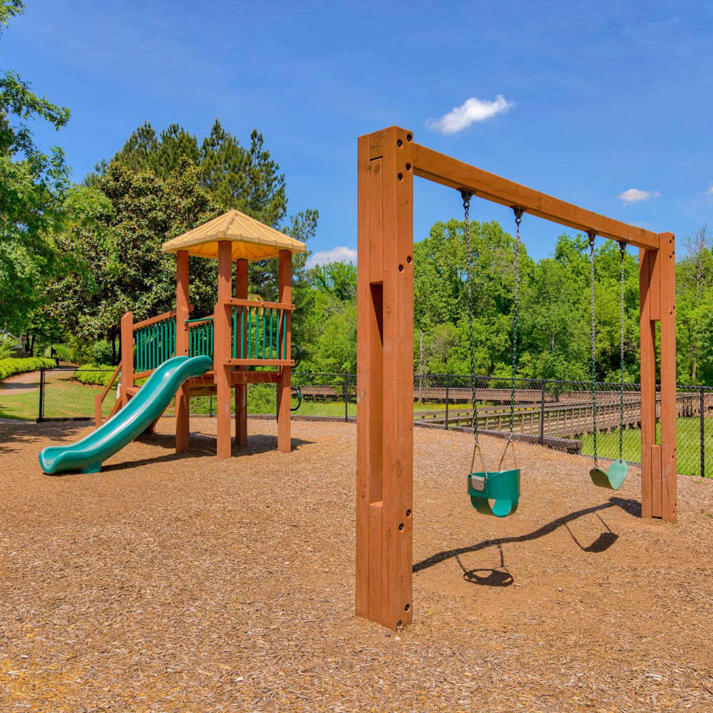 Playground with swings at Avonlea Towne Lake in Woodstock, Georgia