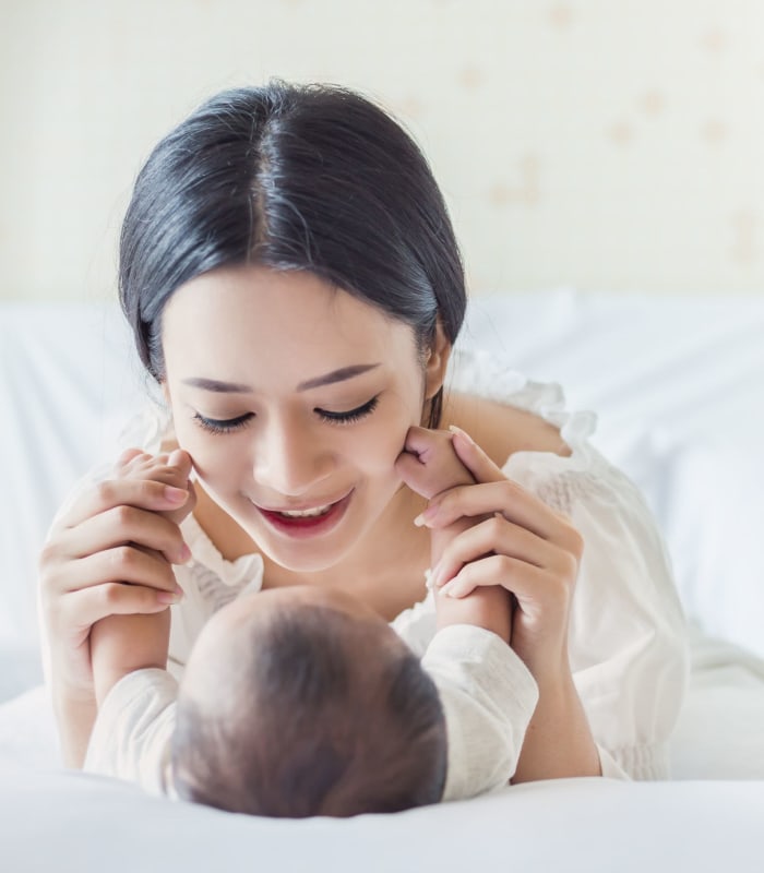 Mother playing with her baby at Apple Creek Apartments in Stillwater, Oklahoma