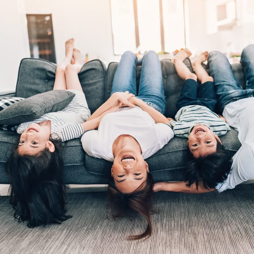 A family relaxing on a couch in a home at Kansas City in Belton, Missouri