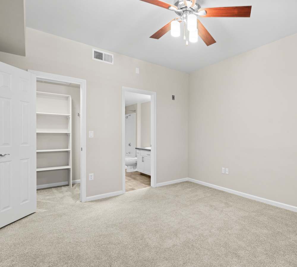 Bedroom with walk-in closet and en-suite bathroom at Veridian at South Meadows in Reno, Nevada