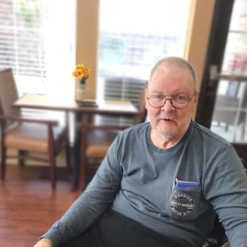 Resident smiling at Oxford Glen Memory Care at Grand Prairie in Grand Prairie, Texas