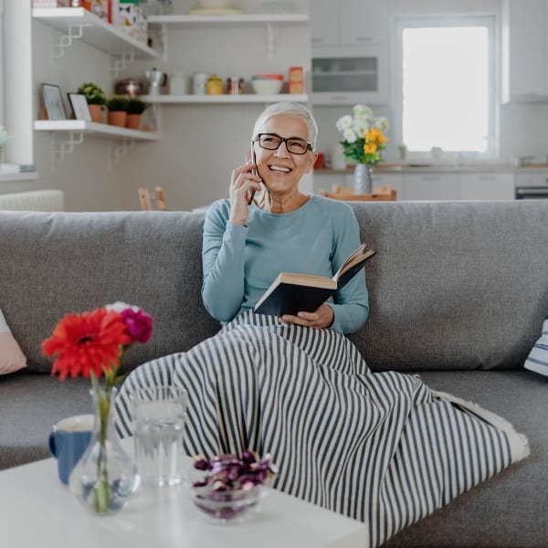 A resident sitting in her cozy apartment at Pacifica Senior Living Fresno in Fresno, California.