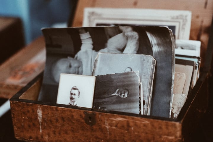 An open box of organized old family photographs