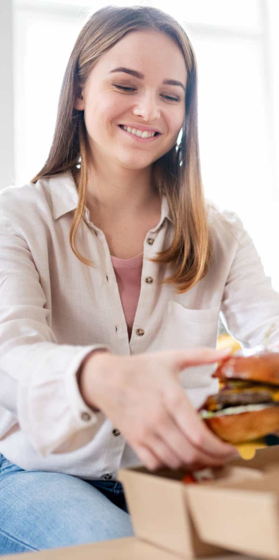 Student enjoying a tasty burger at The Lex in Lexington, Kentucky