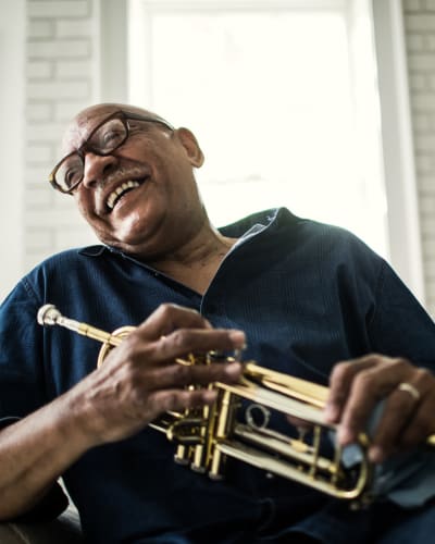 Resident smiling with trumpet Trustwell Living at Urbana Place in Urbana, Ohio
