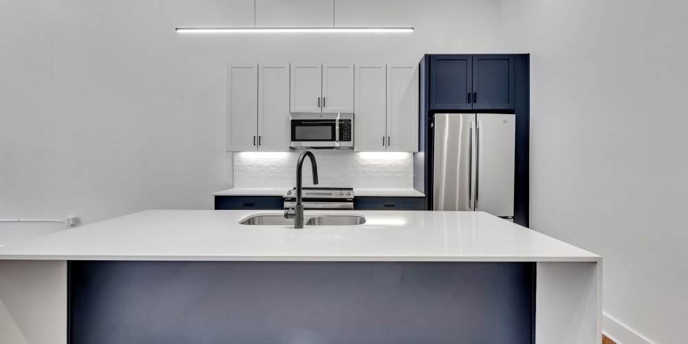 An open kitchen with center island in a loft apartment at Theatre Lofts in Birmingham, Alabama