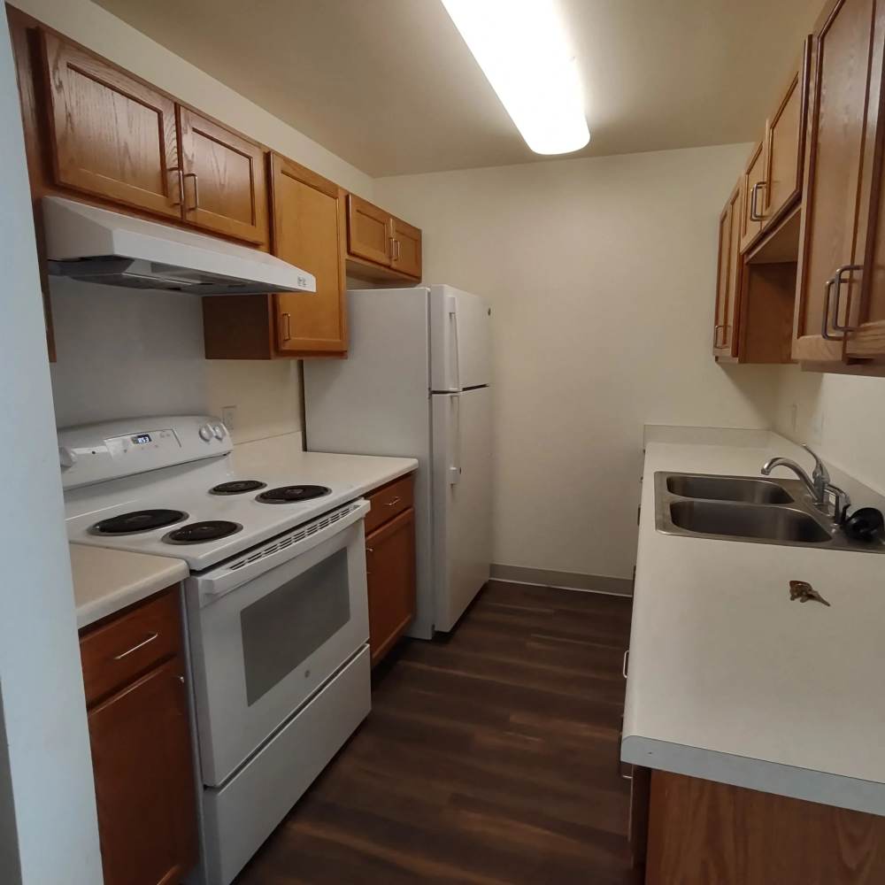 Kitchen with the necessary appliances at Willow Creek Apartments in Escanaba, Michigan