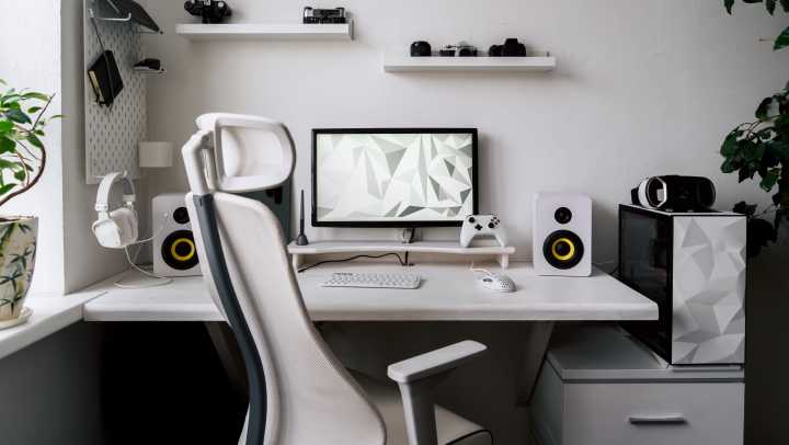 Simple white game room featuring game room organization, including shelves, cabinets, and a pegboard 