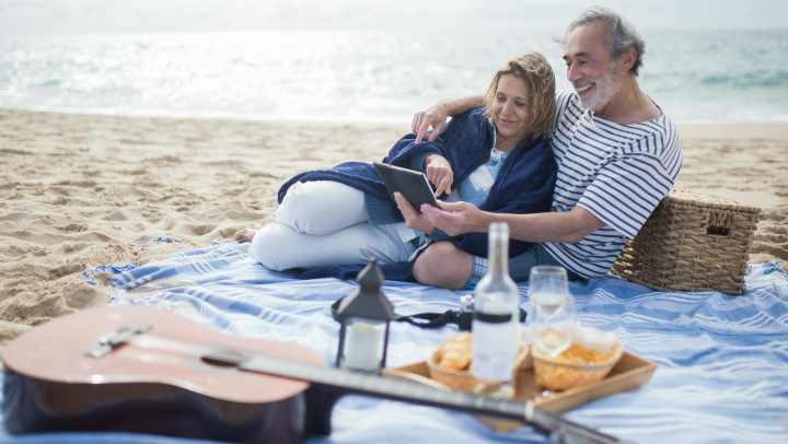 Elder couple enjoying picnics at the beach