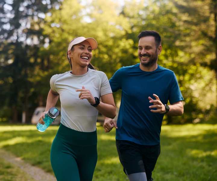 A man and woman jogging together in a park near Magnolia Terrace in Tallahassee, Florida