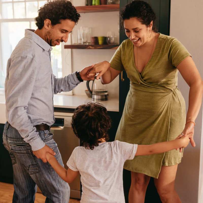 A family dances in their apartment at Commons on Potomac Square, Sterling, Virginia