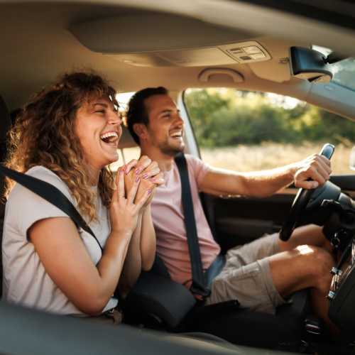 Couple going on a drive in a car near Stone Village Apartments in Reno, Nevada