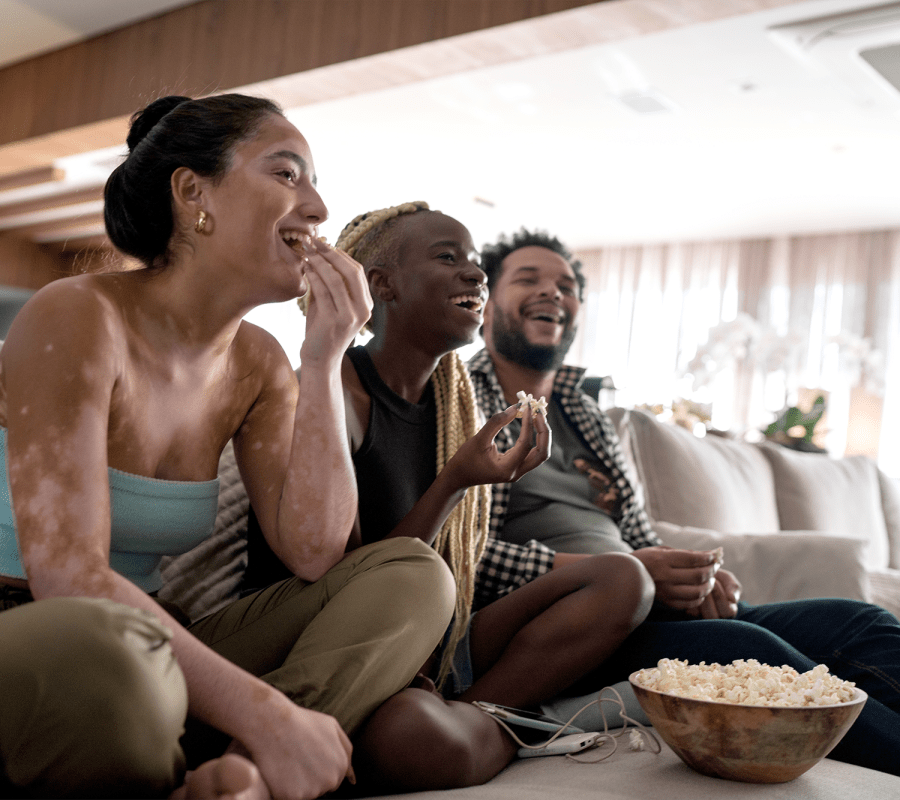 Friends watching something funny and laughing together at Reserve at the Ballpark in Atlanta, Georgia