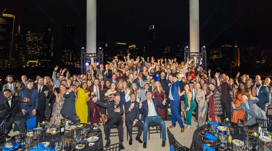 Team posing for a photo at an awards ceremony at our corporate offices at Campus Life & Style in Austin, Texas