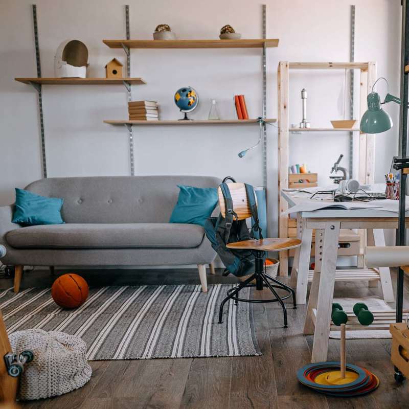 Living room with shelves and proper lighting at Heron Creek Apartments in Moses Lake, Washington