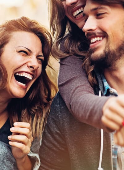 Friends laughing together near The District in Charlotte, North Carolina