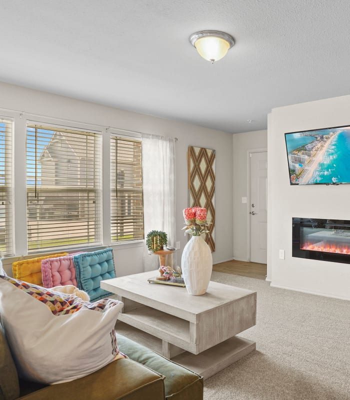 Spacious living room with large windows at Cottages at Crestview in Wichita, Kansas