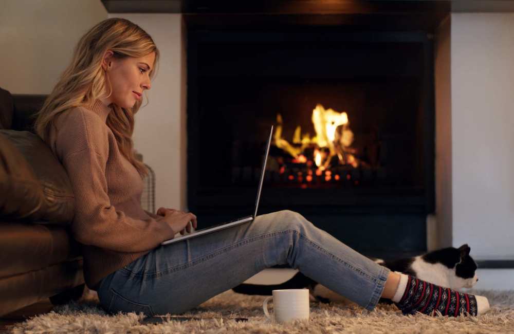 Resident and her cat sitting by the fire place at Athena Garden Apartments in Athens, Texas