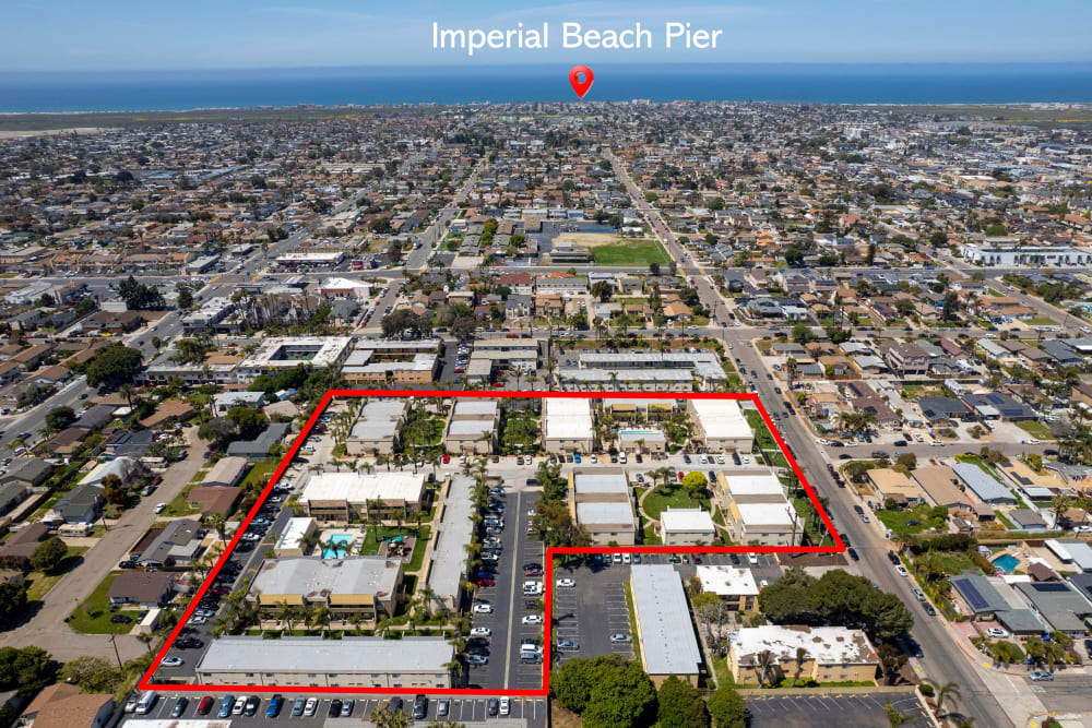 Ariel view of the community at Royal Village Apartments in relation to the Imperial Beach Pier in San Diego, California