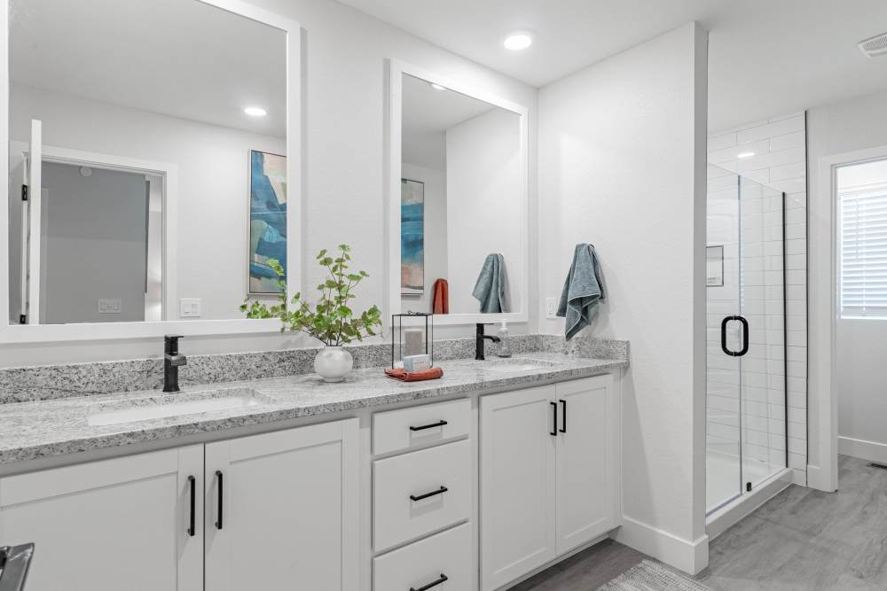 Double vanity bathroom with featuring shower 