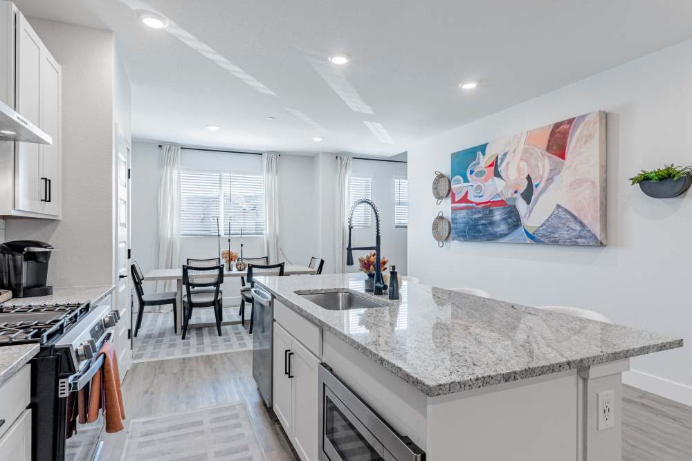Kitchen featuring island and dining area at BB Living Trails Edge in Centennial, Colorado