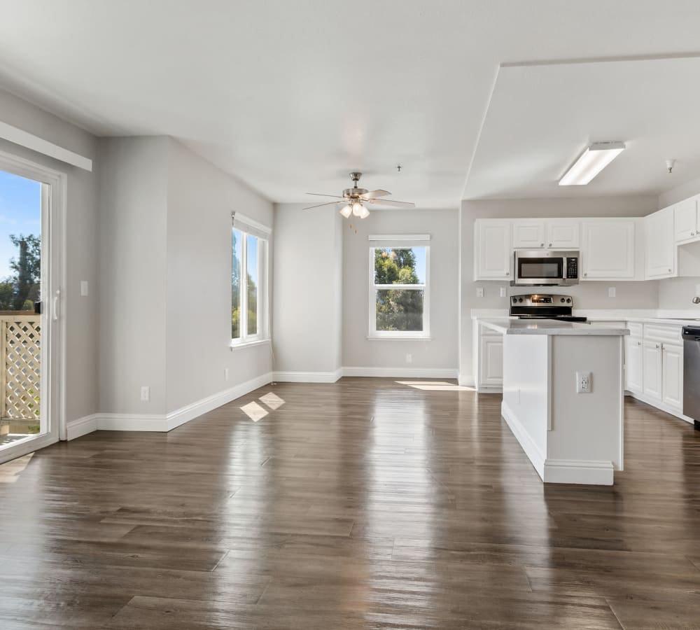 Spacious floor plan with wood-style flooring at Quail Hill Apartment Homes in Castro Valley, California