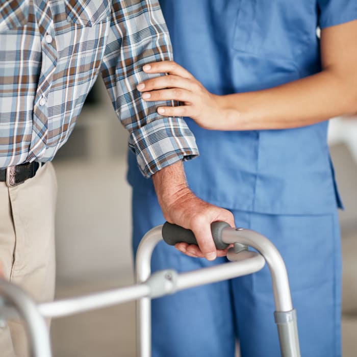 Resident being supported by caregiver at The Club at Haines City in Haines City, Florida