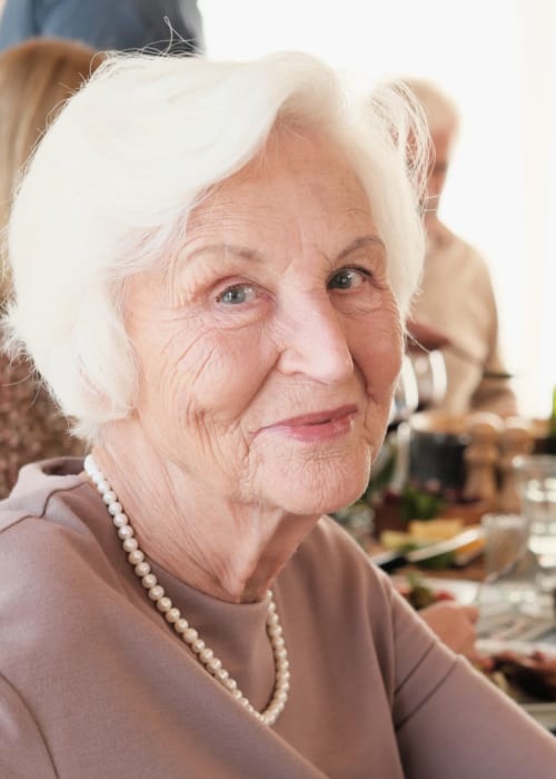 Happy resident having meal at Grand Villa of Lakeland in Lakeland, Florida