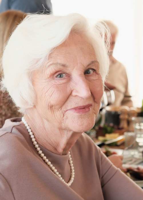 Happy resident having meal at The Pineapple House at Sapphire Lakes in Naples, Florida