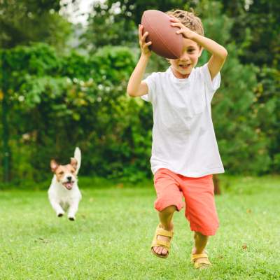 Resident child having fun with dog at Fifteen in Miami, Florida