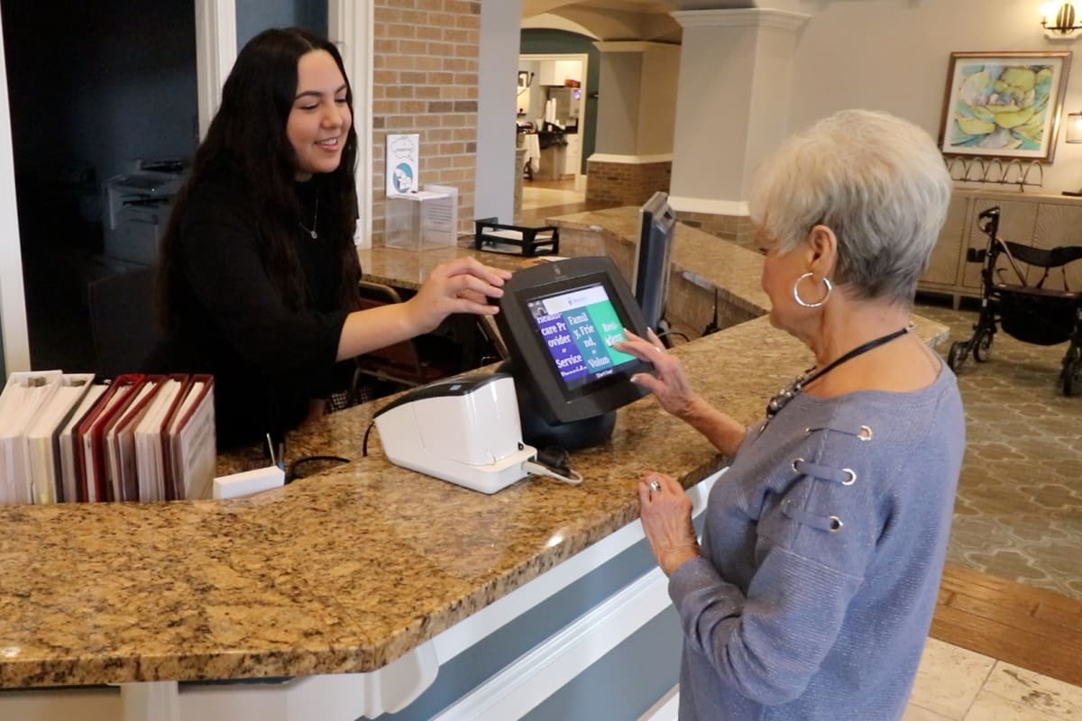 Staff member ringing up a resident at Watermere at the Preserve in North Richland Hills, Texas. 