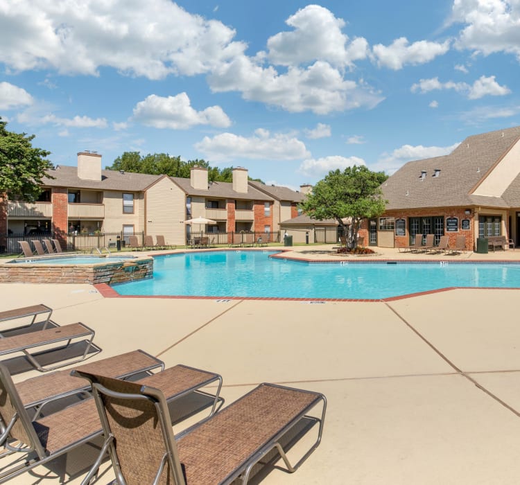 Swimming pool with a sundeck at The Logan in Bedford, Texas