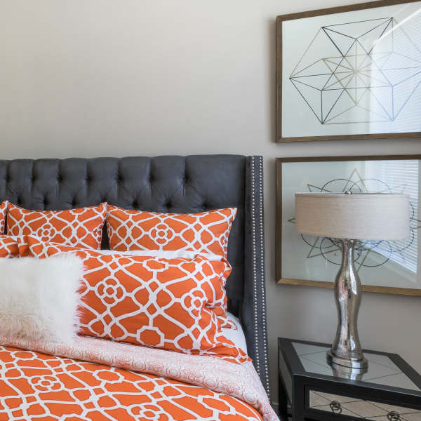 Bedroom with night stand and lamp at Attain at Quarterpath, Williamsburg, Virginia