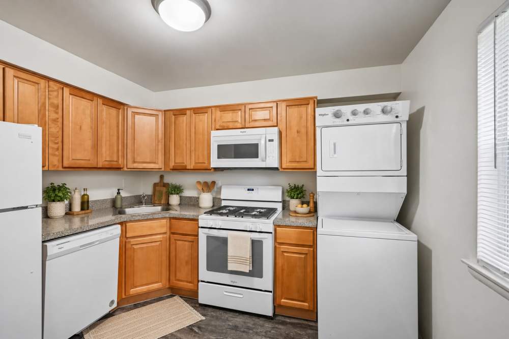Bright, modern kitchen with unitized Washer and dryer at The Fairways Apartment Homes in Blackwood, New Jersey