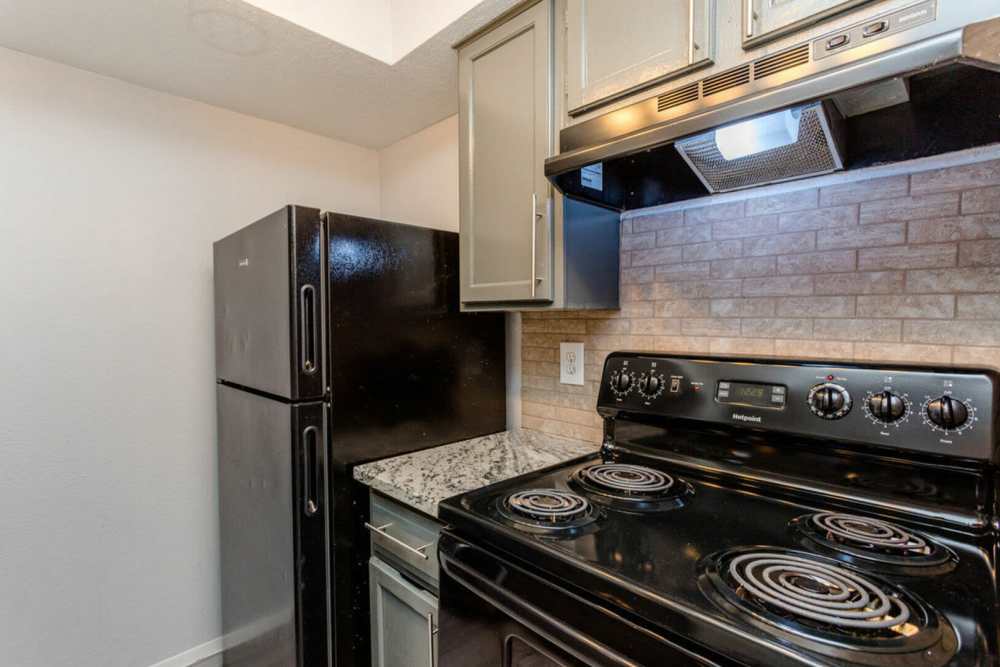 Modern kitchen with a refrigerator at Pine Lake Village in Houston, Texas
