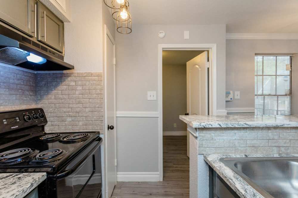 Kitchen with wooden cabinets at Pine Lake Village in Houston, Texas
