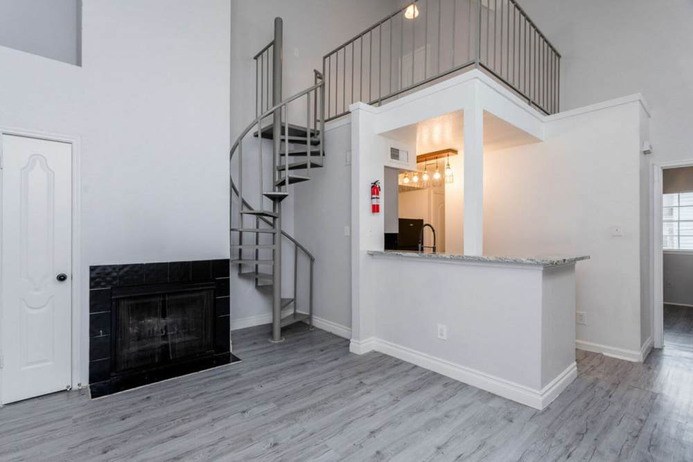 View of the kitchen and the stairs leading to the above floor at Pine Lake Village in Houston, Texas
