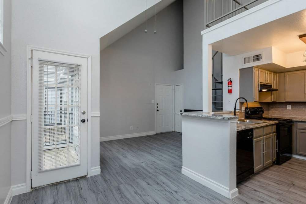 Combined view of the living room and the kitchen at Pine Lake Village in Houston, Texas