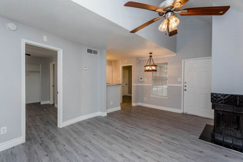 Spacious living room with a ceiling fan at Pine Lake Village in Houston, Texas
