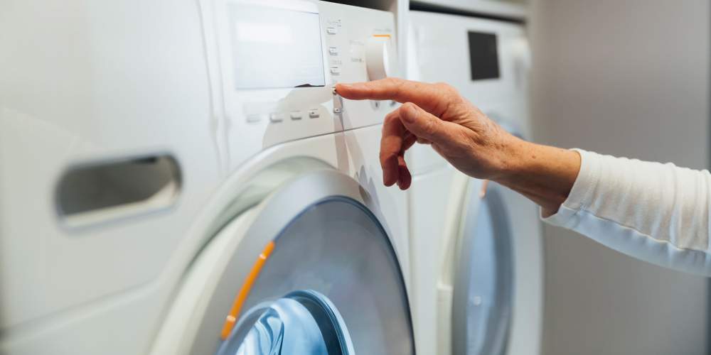 Woman using modern washer and dryer at Forest Ridge in Fort Mill, South Carolina