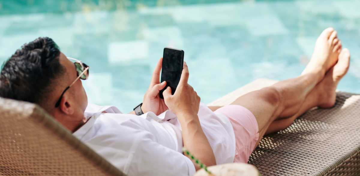 A resident relaxes by the pool at Pinnacle Apartments, Hampton, Virginia 
