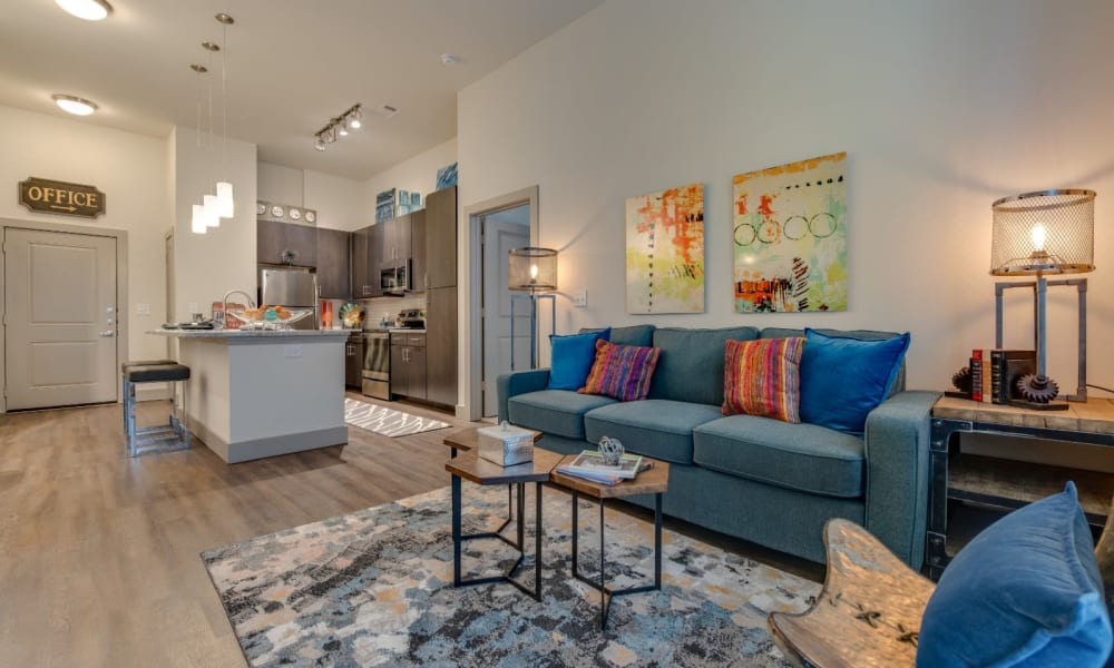 Spacious living room in model home with cute rug at Bellrock Upper North in Haltom City, Texas