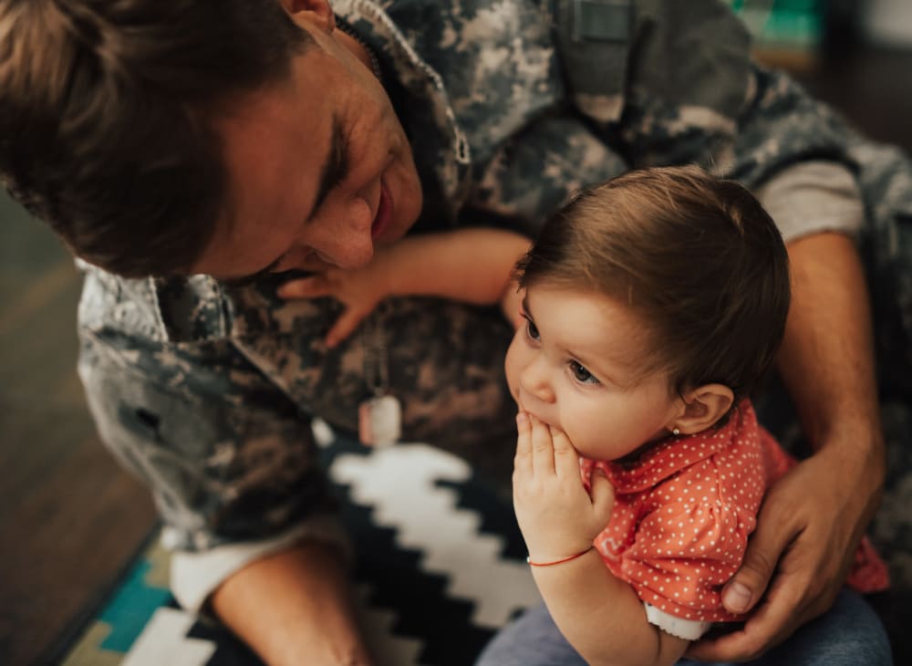 A resident father in a uniform and his daughter in a home at Navy Submarine Base Pt. Loma in San Diego, California
