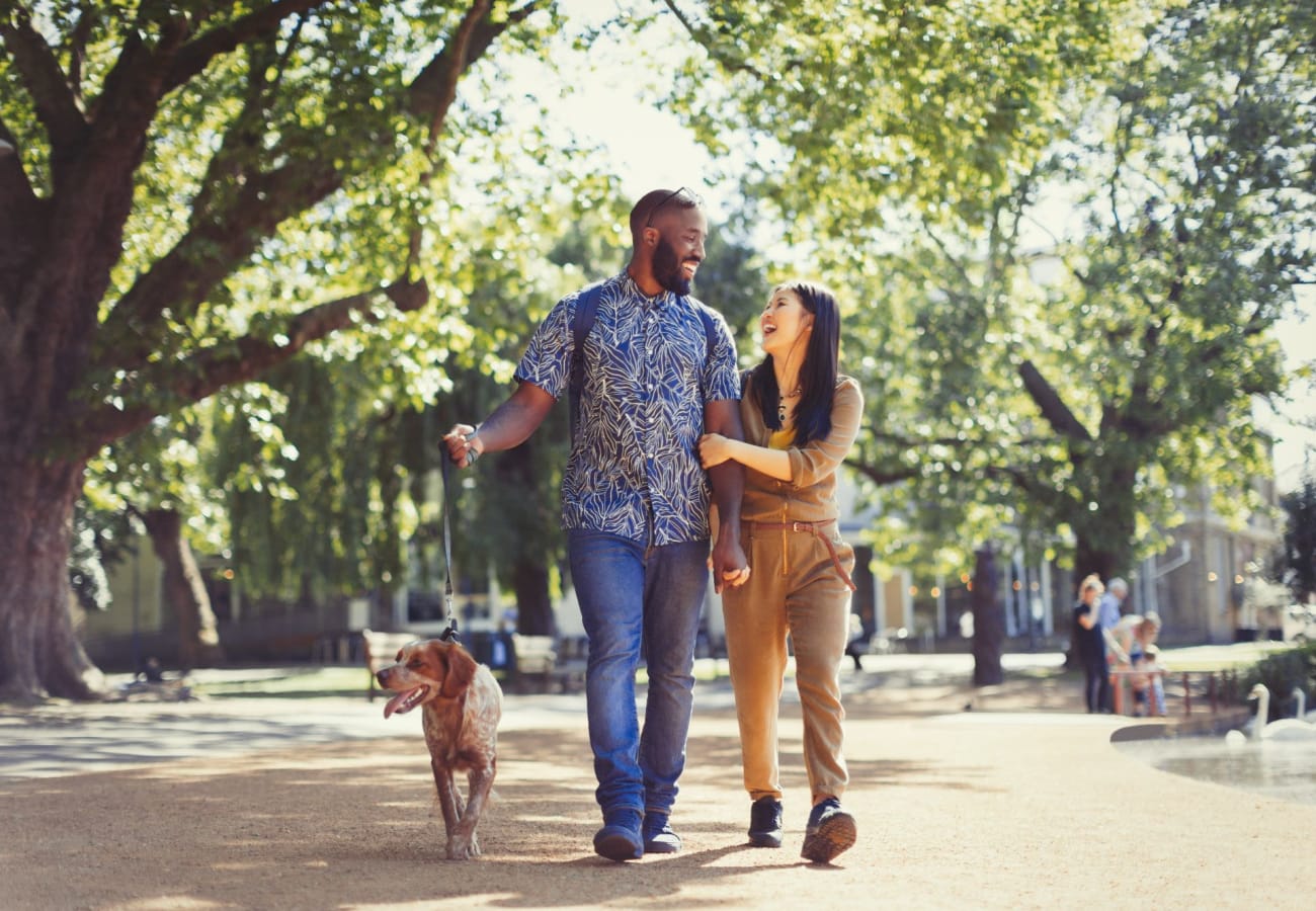 A couples walks in the park with their dog at Macland in Dallas, Georgia